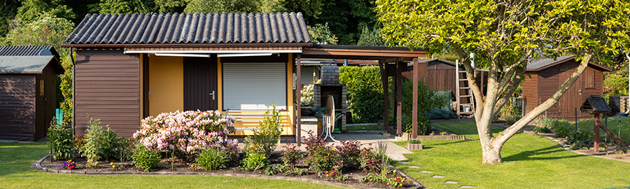 A carport attached to a small carriage house